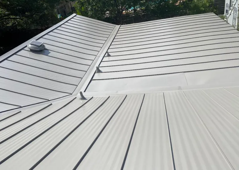 Solar attic fan installed on a metal roof for Roof Ventilation in Delmar